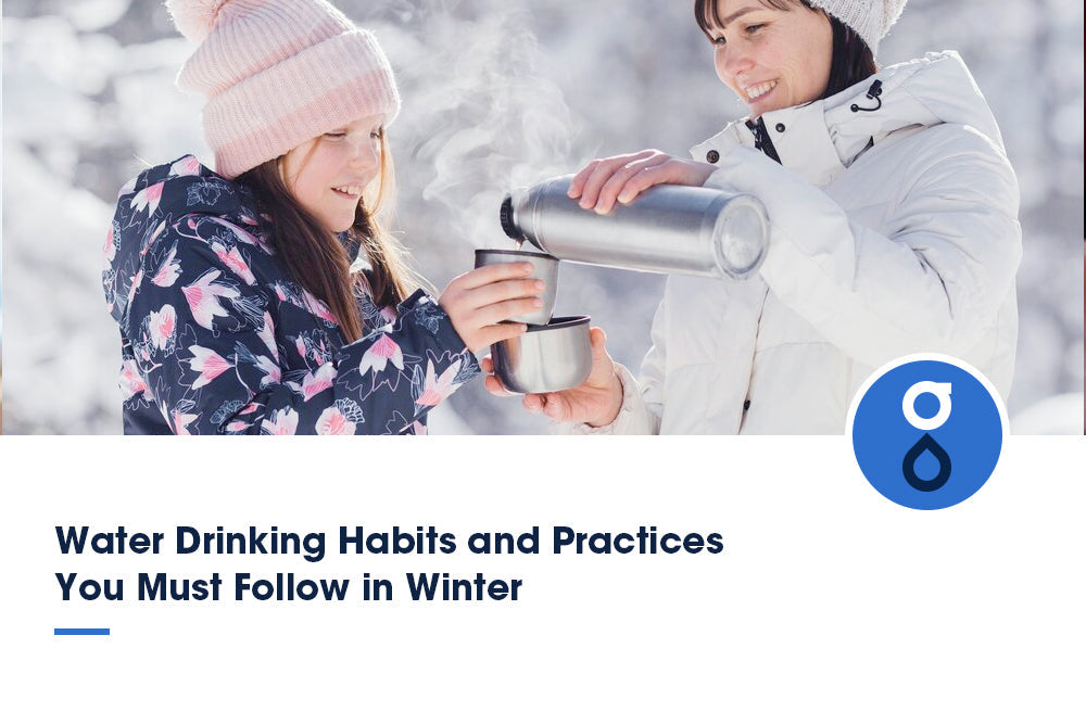 Two people dressed warmly are pouring hot water from a thermos into a cup, highlighting winter water drinking habits. The text reads: "Water Drinking Habits and Practices You Must Follow in Winter."